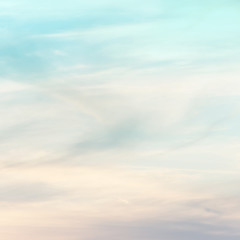 Fototapeta premium sunset background. sky with soft and blur pastel colored clouds. gradient cloud on the beach resort. nature. sunrise. peaceful morning. Instagram toned style