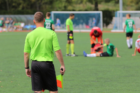 The line referee observes the situation on the football field