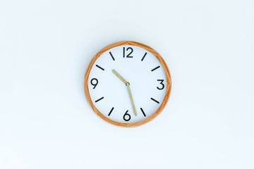 trditional clock on white wall background isolated