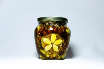 Nuts and assorted nuts in a jar of honey and brown bread with cereals