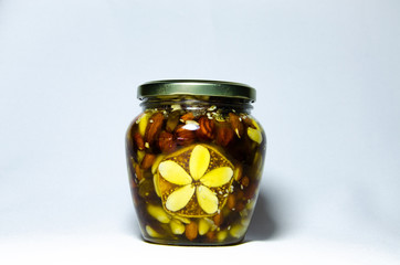Nuts and assorted nuts in a jar of honey and brown bread with cereals