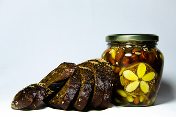 Nuts and assorted nuts in a jar of honey and brown bread with cereals