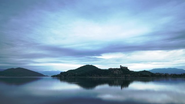 Italy Castle Rocca di Angera Arona morning timelapse. Fast moving clouds and increasing luminosity