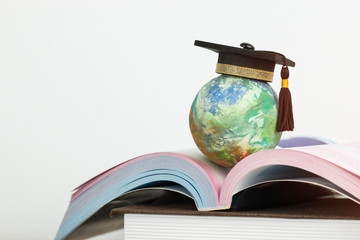 Study abroad education in Global ideas: Graduated cap on top global model on open textbook in...