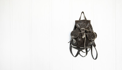 Black leather backpack for the traveler on a white background. Traveler