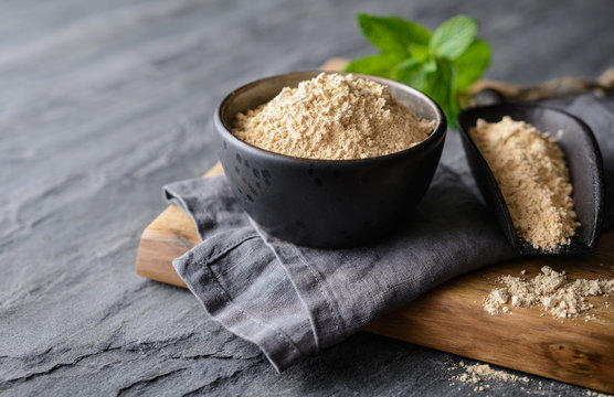 Dietary supplement, Maca root powder in a bowl and scoop with copy space