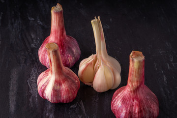 top down view of garlic, garlic peel, on a black slate