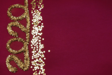 Symbol of the new year. Tinsel's numbers 2020. Glitter stars on a red background. New year celebration flat lay concept.