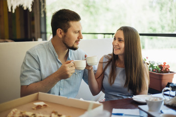 Happy couple having breakfast with coffee