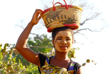 Portrait of Malagasy woman with traditional mask on the face, Madagascar