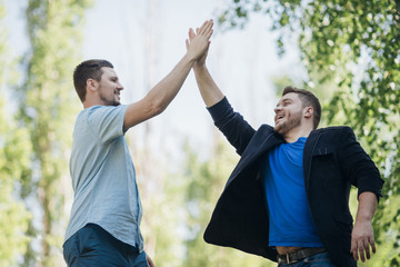 Satisfied friends giving high five