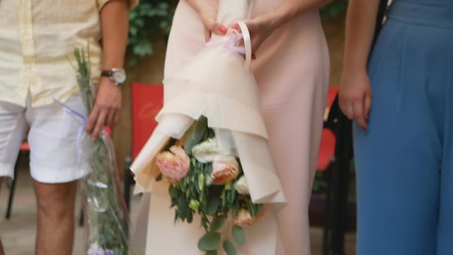 guests with a bouquet before the wedding ceremony