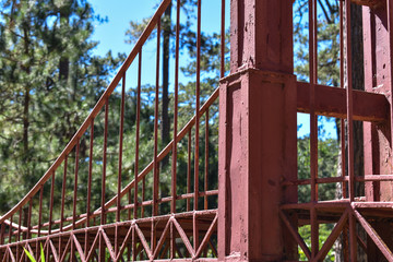 Fototapeta na wymiar A small red bridge designed in the middle of a park