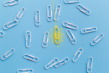 Great ideas concept with paperclip,thinking,creativity,light bulb on blue background,new ideas concept.