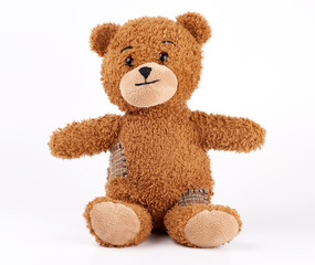 brown vintage teddy bear with patches