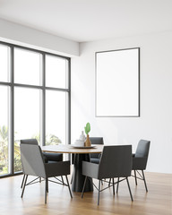 Minimalistic white dining room corner with poster