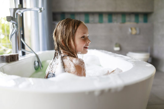 Smiling Girl Looking Away In The Bathroom