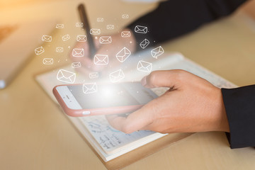 Business people check email communication information (Mail icon) with a modern and fast smartphone connected to the 5G network