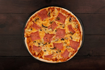 Italian pizza over wooden vintage table