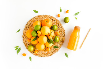 Background made of summer tropical fruits: orange, lemon, lime and juice on white background. Food, drink concept. Flat lay, top view summer concept.