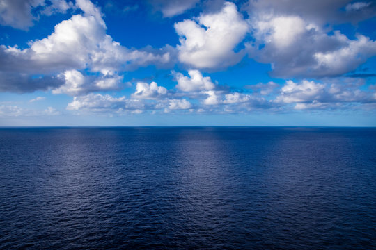 Calm ocean and a few clouds off the coast of Hawaii