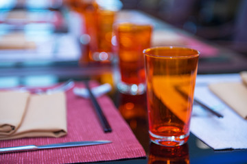 Orange Grass on Mirror Table with Colorful Bokeh Background