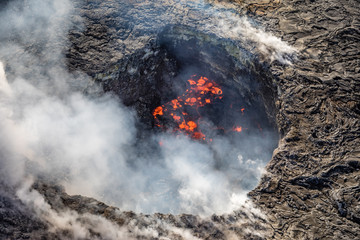 Looking down into the crater of boiling lava smoke and toxic gas at Volcano National Park on the big island of Hawaii