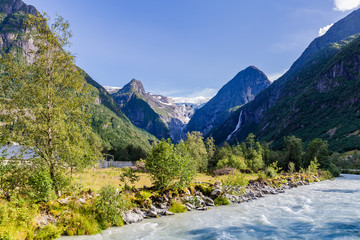 Naklejka na ściany i meble Oldedalen valley with majestic mountains, rivers, waterfalls and impressive Jostedalsbreen glacier in the background in Norway, Scandinavia
