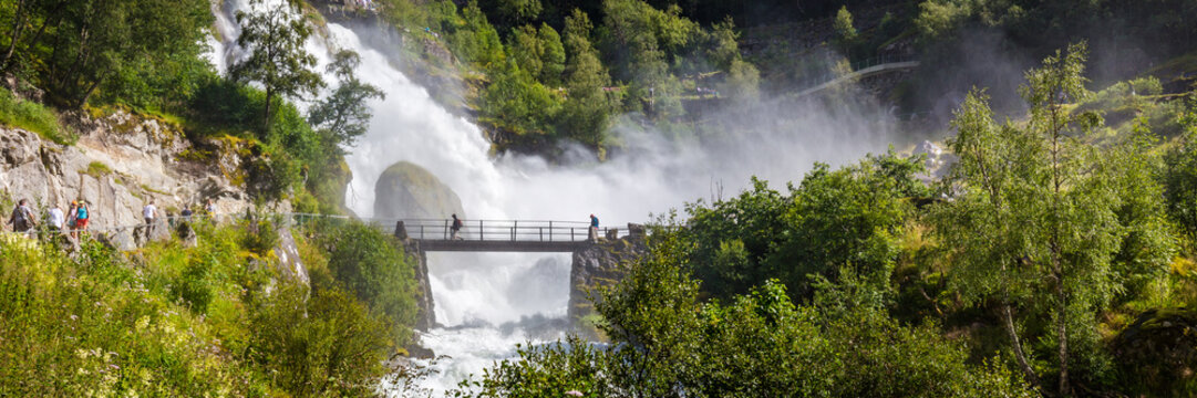 Bridge and waterfall with melting water of the Briksdal glacier in Norway, arm of Jostedalsbreen glacier in Oldedalen valley in Norway, Scandinavia.
