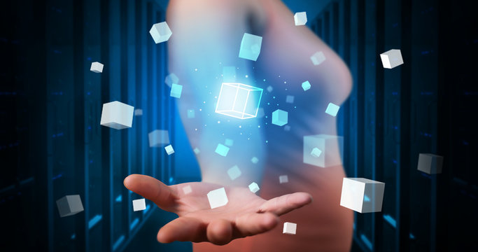 Person holding hologram projection displaying white cubes in server room