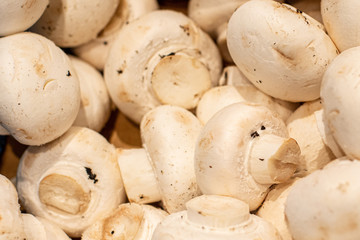 Fresh button mushrooms piled on the market. Food backgroumd. Harvest