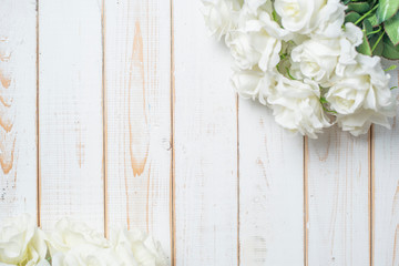 Top view of wedding flowers on white wood background