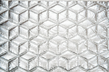 Fabric quilted glossy silver. Quilted fabric texture. Textile disco style.
