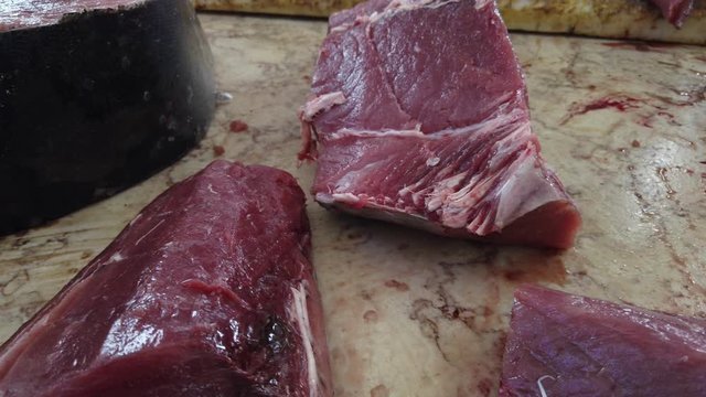 Close up and panning of tuna sliced pieces in "Mercado dos Lavradores" market, Madeira island, Portugal