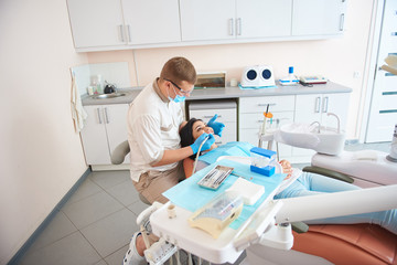 Woman having dental procedure at modern clinic