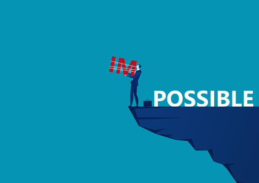 business man holding impossible text for abandoned IM word on top mountain, metaphor to success, challenge, motivation,achievement,concept