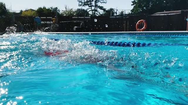 Athletic Young woman professional triathlon swimmer practicing at pool. Girl swimming breaststroke