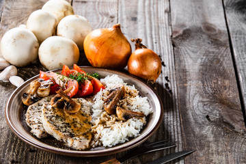 Grilled pork chop with white rice and mushroomson