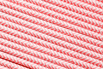 Pink paper straws . Cocktail tubes as a background close-up