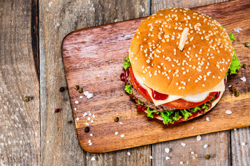 Tasty burger on cutting boarrd