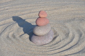 4 Steine übereinander im Sand am Meer