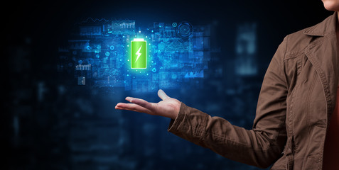 Elegant hand holding battery with full of energy