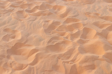Fototapeta na wymiar closeup sand pattern of a beach in the summer.