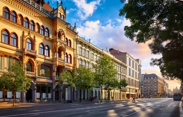 Rolgordijnen Evening street big city Budapest Hungary. Picturesque sunset. Landscape with residential and commercial house. Panorama road. © Yasonya