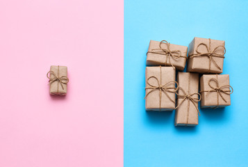 Gender determination day concept. Set of gift boxes. Pink and blue backgrounds. Girl or boy. Parcels wrapped in craft paper. 