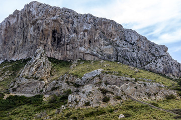 View on mountain range at bay Cala Figuera on balearic island Mallorca, Spain on a sunny day with blue sky and white clouds