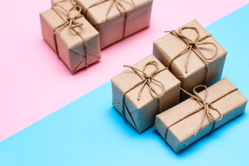 Gender determination day concept. Set of gift boxes. Pink and blue backgrounds. Girl or boy. Parcels wrapped in craft paper. 
