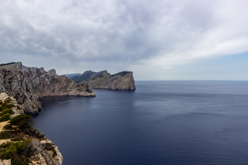 Fototapeta na wymiar Scenic view on the coast at bay Cap de Formentor on balearic island Mallorca, Spain on a sunny day with clear blue water an rocky coastline