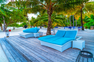 Lounge chairs on a beautiful tropical beach at Maldives