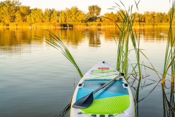 Inflatable stand up paddleboard on lake